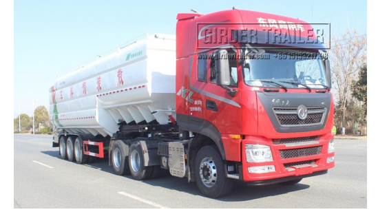 Bulk feed trailer with red truck cab side view