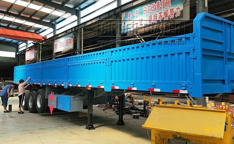 Blue drop side trailer in warehouse