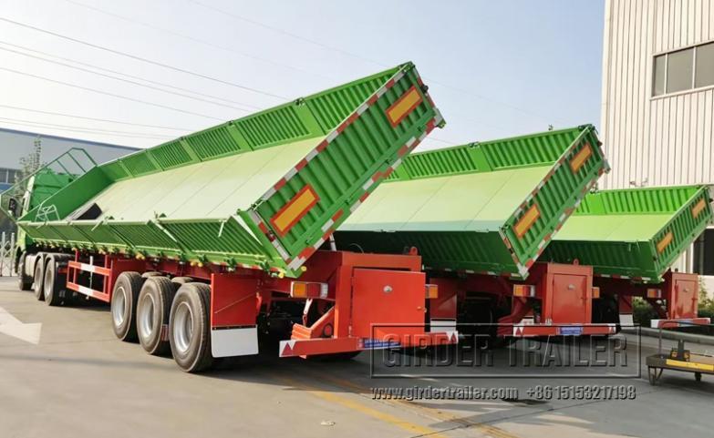 Green drop side dump trailer tipping