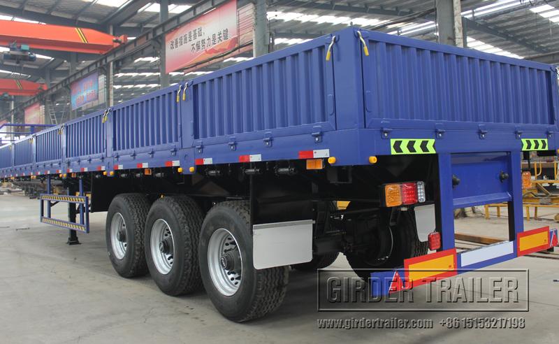 Blue drop side trailer panel road view