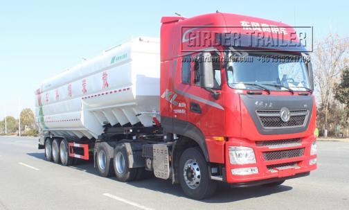 White bulk feed trailer with red truck