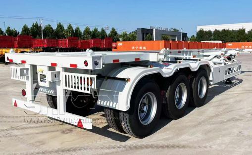 White skeleton trailer with red guard rails