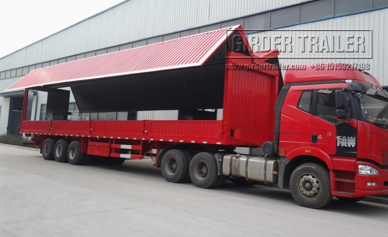 Red wing van trailer with wing panel open on truck