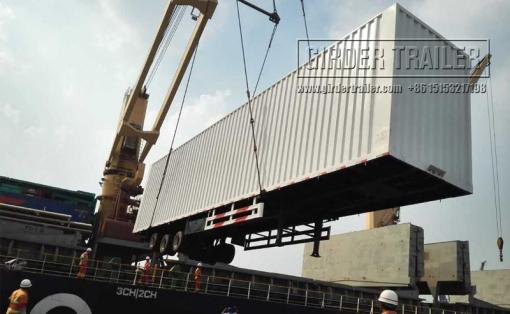 Crane loading box trailer body onto ship