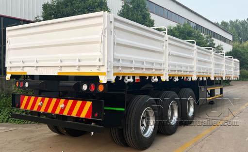 Drop-side flatbed trailer red loaded