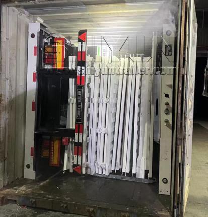 Trailer side panels folded inside shipping container