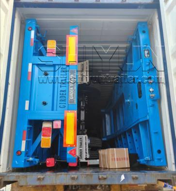 Blue flatbed trailer intact inside 45 foot container