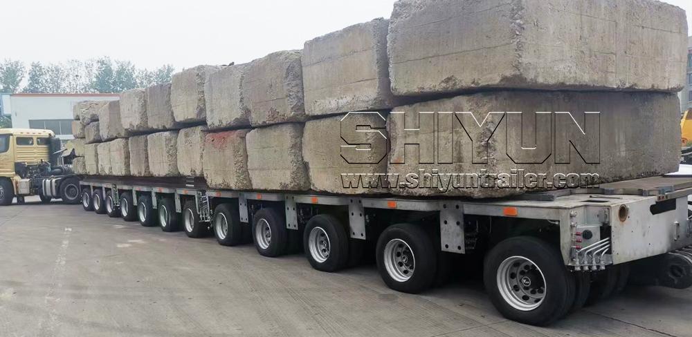 Modular trailer transporting large concrete blocks