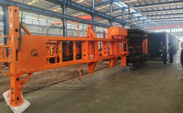 Orange trailer fully assembled inside warehouse