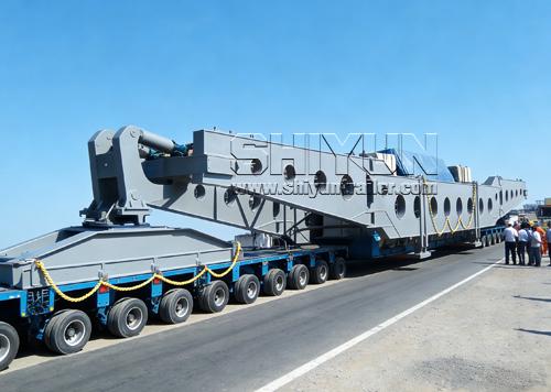 Girder bridge trailer transporting long beam on road