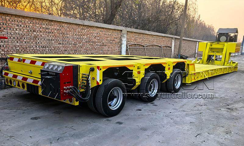 Yellow low-profile drop deck modular trailer with gooseneck
