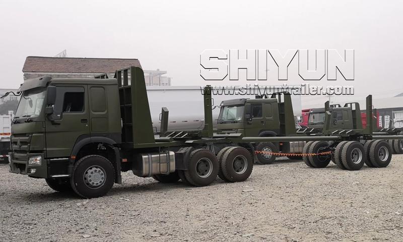 Log draw bar trailer towed by military truck